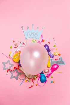 Celebration Flat lay. Candy with colorful party items on pink background.