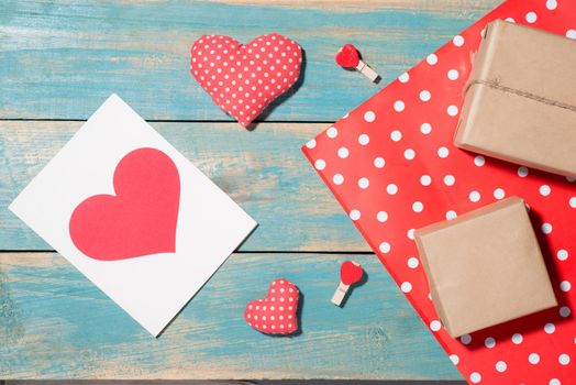 Valentine's Day greeting card over wooden background. Top view with copy space
