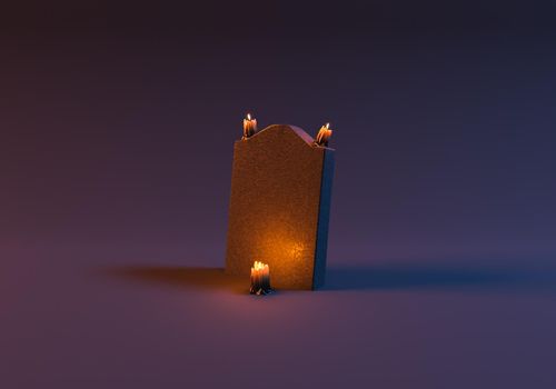 tombstone with lighted candles