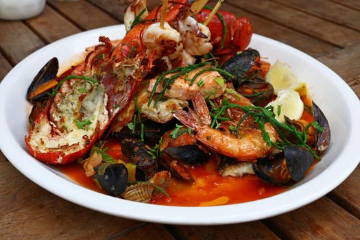 Grilled seafood platter on wooden table
