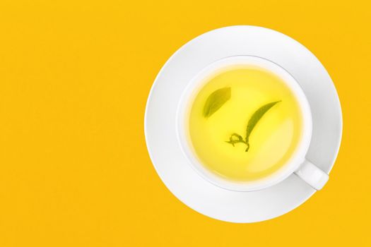 Cup of green oolong tea over yellow