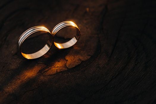 Two wedding engagement rings on a wooden base For a gold ring of a loving wedding couple.Concept of love.