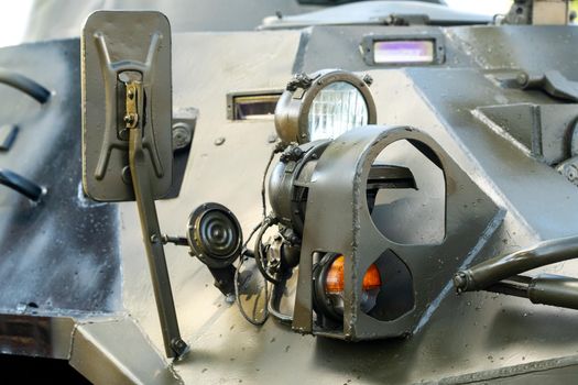 Headlights of an armored combat vehicle. Close-up of combat military equipment with light lights
