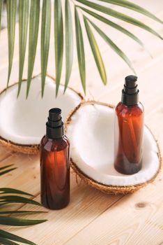 Coconut oil with fresh coconut for alternative therapy on wooden background