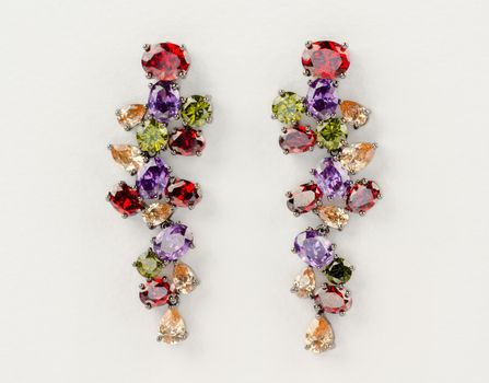 Beautiful fashion earrings shot on designer paper background