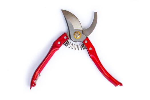 Garden pruner with red iron handles. Cutting scissors on a white background