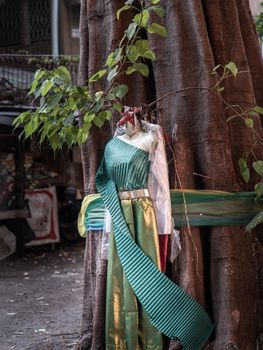 Traditional thai costumes and fabric colors colorful wrapped around the big tree is the belief of the Thai villagers.