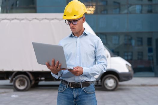 Business. Engineer Worker Protective Helmet Use Laptop Controls Working Process Inspector Supervisor Yellow Hard Hat Glasses Transportation Company