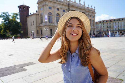Portrait of stylish traveler girl walking in Turin, Italy