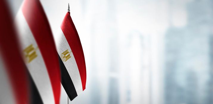 Small flags of Egypt on a blurry background of the city