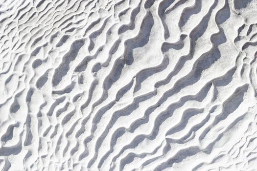 Gray-white texture of calcium travertine, pattern of diagonal waves