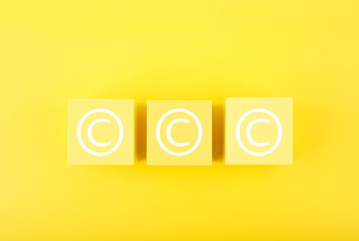 Copyright and intellectual property protection concept on yellow background 