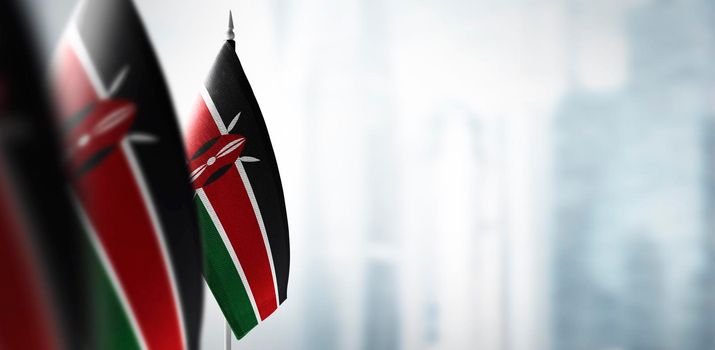Small flags of Kenya on a blurry background of the city