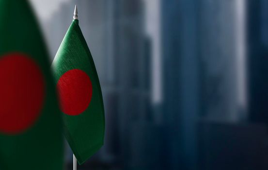 Small flags of Bangladesh on a blurry background of the city