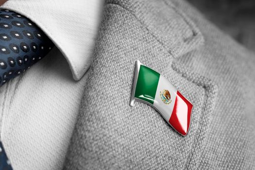 Metal badge with the flag of Mexico on a suit lapel
