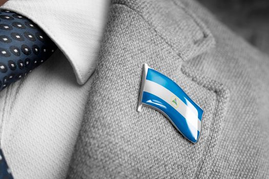 Metal badge with the flag of Nicaragua on a suit lapel
