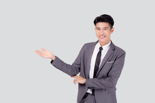 Portrait young asian business man in suit presenting isolated on white background, advertising and marketing, executive and manager, male confident showing success, expression and emotion.