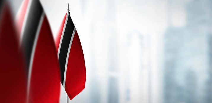 Small flags of Trinidad and Tobago on a blurry background of the city