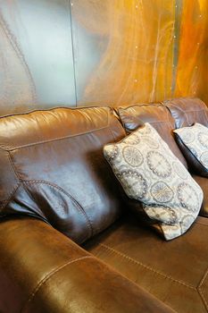 white pillow on leather sofa