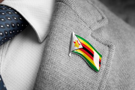 Metal badge with the flag of Zimbabwe on a suit lapel