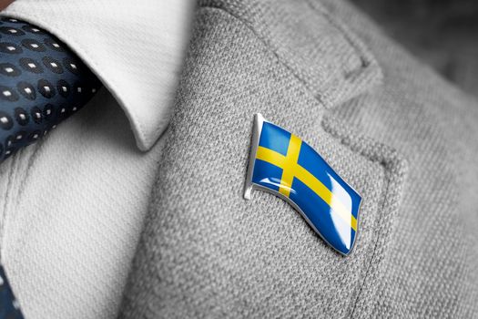 Metal badge with the flag of Sweden on a suit lapel