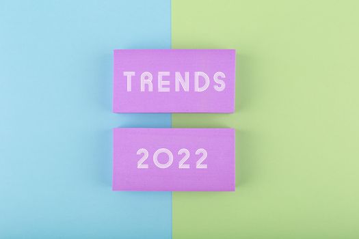 Trends 2022 written on purple rectangles on green and blue background