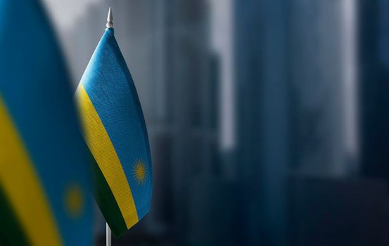 Small flags of Rwanda on a blurry background of the city