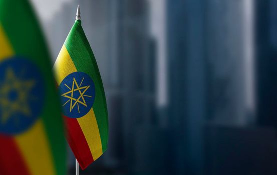 Small flags of Ethiopia on a blurry background of the city