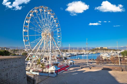 Antibes, France. Giant ferris wheel and yachting harbor view in town of Antibes, French riviera