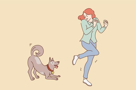 Fear of dogs animals concept. Young stressed girl feeling afraid running away from friendly playing dog outdoors vector illustration