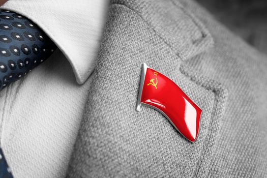 Metal badge with the flag of USSR on a suit lapel