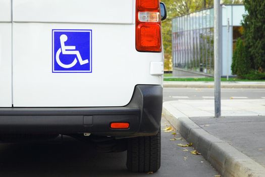 Disability sign on minivan back door, public transport accessibility