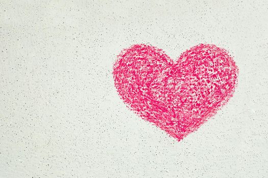 Pink heart drawn with chalk on white wall, copy space