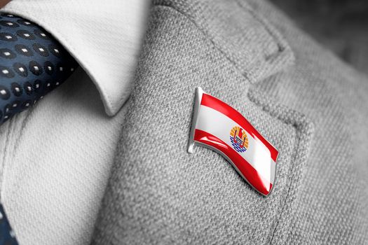 Metal badge with the flag of French Polynesia on a suit lapel