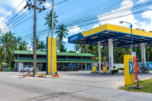 Gas station in Thailand. Palm trees on the background