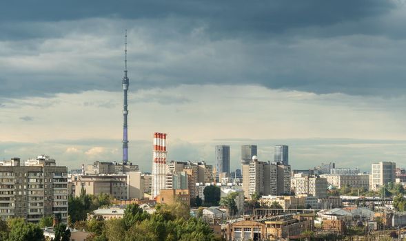 Ostankino Tower above Moscow cityscape in summer, Russia. Panorama of Moscow and TV tower on blue sky background. Moscow city skyline with Panoramic view of Moscow residential district
