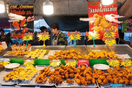Snack and fried chicken stall at a market in Asia