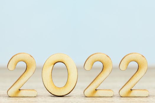 Wooden numeric new year 2022 on table