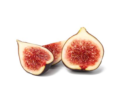 whole fruit and fig slices on white background