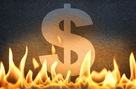 US dollar symbol burning in fire flames