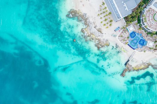 Aerial view of sandy beach and ocean with small waves in Cancun, Mexico. Top view from drone. Playa Caracol of Riviera Maya in Quintana roo region on the Yucatan Peninsula