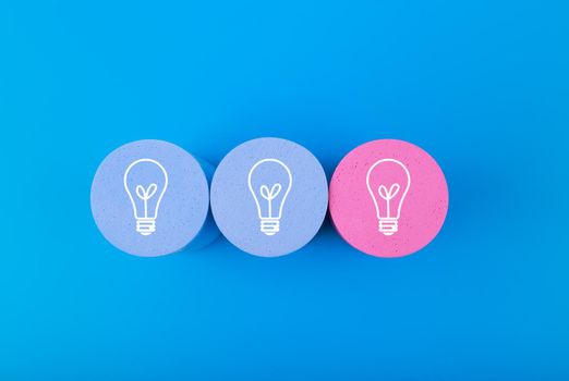 Creativity concept. Light bulbs on blue and pink circles on saturated blue background