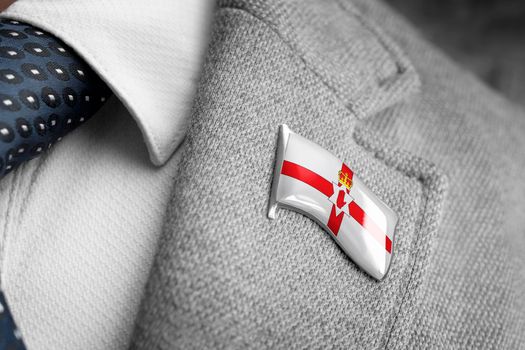 Metal badge with the flag of Northern Ireland on a suit lapel