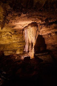 View of large stalagmites and stalactites connecting in column of cave