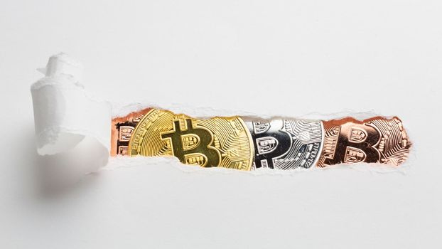 ripped paper revealing bitcoin. High quality photo