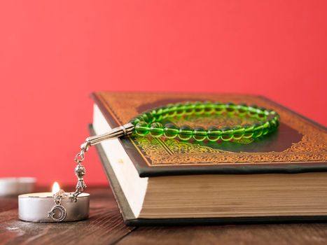 close up quran table with prayer beads