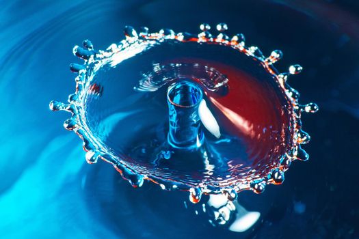 Blue and red water drop collision from above