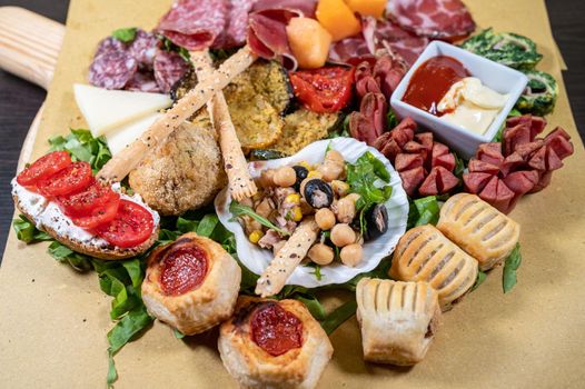 mixed antipasto platter with cold cuts and legumes and cheeses