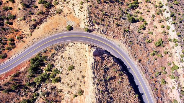 Road curving through desert hills