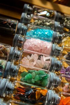 Small apothecary or witchy vials filled with rocks and crystals